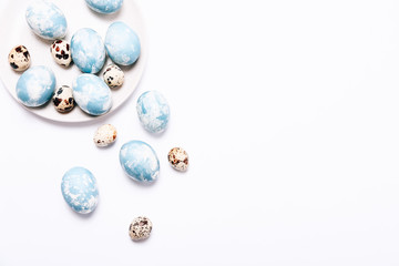 Stylish eggs with ombre blue marble stone effect on white background