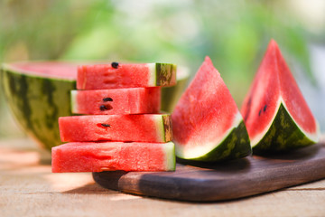 Sliced watermelon on wooden and nature background - Close up fresh watermelon pieces tropical summer fruit
