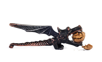 Obraz premium Dragon nutcracker and crushed walnut on a white fon