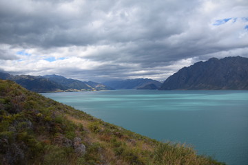 Naklejka na ściany i meble cloudy day over lake Pukaki in New Zealand