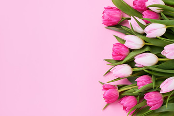 Bouquet of pink tulips on pink background. Mothers day, Valentines Day, Birthday celebration concept. Copy space, top view