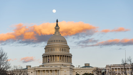 Washington Capitol at sunset with the moon behing it.