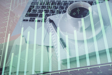Multi exposure of forex graph drawing and desktop with coffee and items on table background. Concept of financial market trading