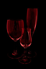 A still life of three different wind glasses on dark background.