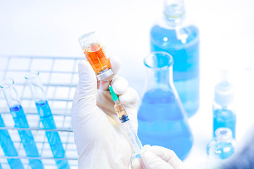 Fototapeta premium scientist in laboratory with test tubes