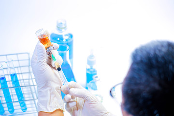 scientist in laboratory with test tubes