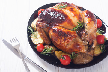 Baked chicken with pototoes , chery tomatoes and rosemary