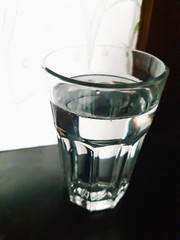 glass of water with ice on black background