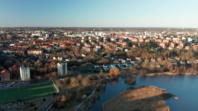 Aerial view of urban residential area with lake and football pitch