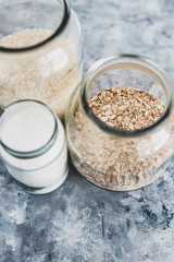 non-perishable food ingredients for vegan pantry, glass jars with oats flour and rice
