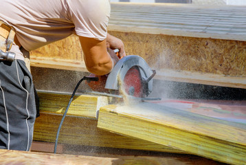 Circular Saw. Carpenter Using Circular Saw for wood beam