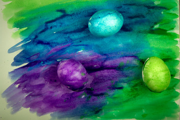 Obraz na płótnie Canvas easter eggs painted with colorful watercolor paint, holiday preparation concept, place for text