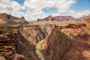 Summer time views in Grand Canyon National Park with blue sky, clouds, Colorado River down below amazing tourist, tourism area of Arizona. 