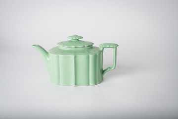 antique green teapot on white background