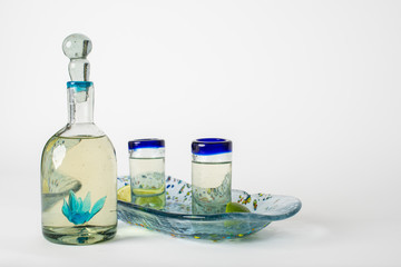 tequila decanter and glass set on white background