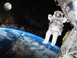 Astronaut on space mission with moon and earth on the background. Elements of this image furnished...