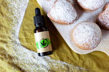 Cannabis oil and cupcakes with marijuana, medical marijuana concept, CBD oil