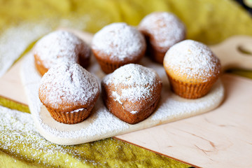 cupcakes hearts on a wooden board on a table