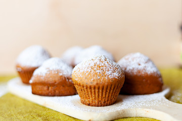 delicious muffin in icing sugar on a table