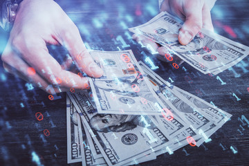 Multi exposure of technology drawing hologram and us dollars bills and man hands. Data concept