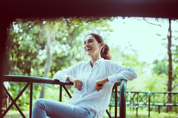 Happy young woman laughing and smiling face at public park