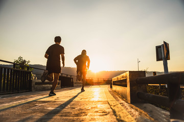 Young man running in the city. Healthy lifestyle concept. Young fitness man runner athlete running at park. soft focus.