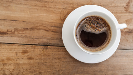 Fototapeta na wymiar black coffee in white cup on wooden background.
