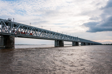 Fototapeta na wymiar Russia, Khabarovsk, August 2019: Road bridge on the Amur river in the city of Khabarovsk in the summer