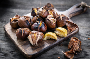 Roasted chestnuts on wooden background