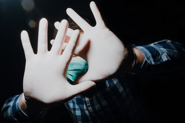 man hands social distancing with medical gloves and mask for protection from corona virus covid-19