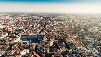 Naklejka premium Beautiful sunny day in city,architecture and landmark of Madrid. Crowded center of capital of Spain.Aerial view of Plaza Mayor in Madrid,Spain. Plaza Mayor is a central plaza in the city of Madrid.