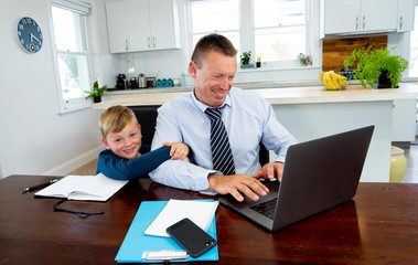 COVID-19 school lockdowns and remote working. Stressed man trying to work from home with bored son