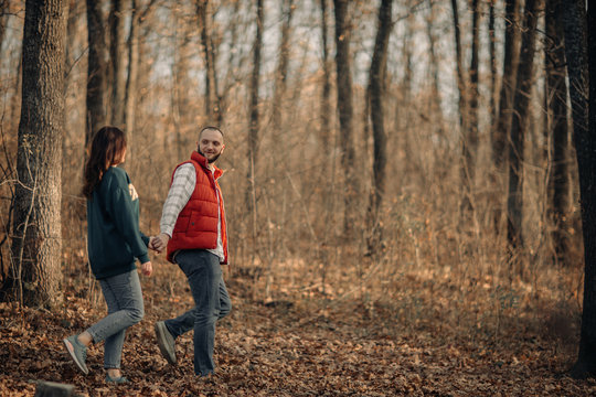 couple walks among the autumn forest in Codri Moldova