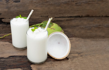 Coconut smoothie drink white fresh cocktail shake milkshake vanilla juice fruit beverage food healthy the taste yummy In glass on wooden background.