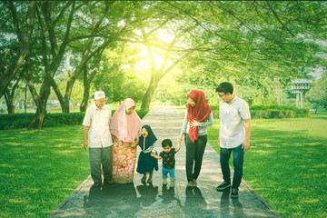 Happy three generation family walking at park