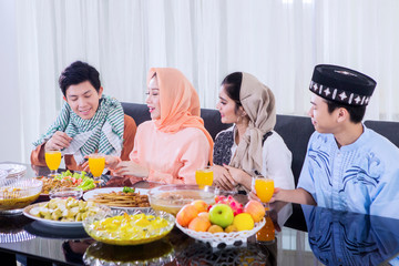 Muslim people chatting together in dining room