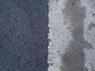 The old gray and new dark grey road asphalt surfaces