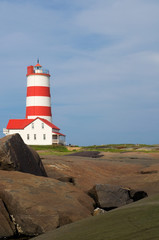 Fototapeta na wymiar Pointe-des-Monts Red and White Historical Lighthouse