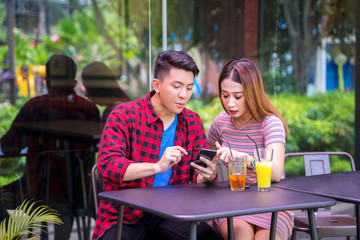 Young couple looking at mobile phone together