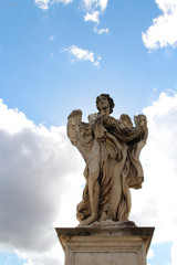 Fototapeta na wymiar Angel Carrying the Garment and Dice by Palolo Naldini at Castel Sant'Angelo, Rome, Italy
