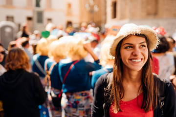 Cheerful tourist visiting to the public celebration,attending carnival.Carnival season.Crowd in costumes traditionally parading street festival.Masquerade in Europe.Colourful vacation © eldarnurkovic