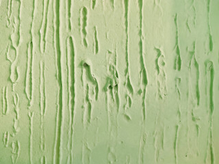 green painted wall, decorative plaster with place for text