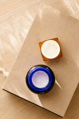 Two open cosmetic crream jars on gift box