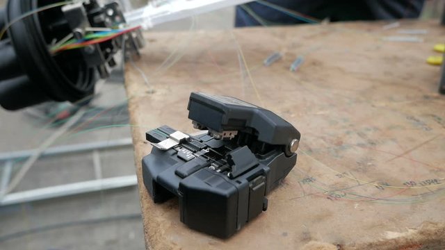 Fiber Splicing Tool Machine in use for connecting fiber optic cable