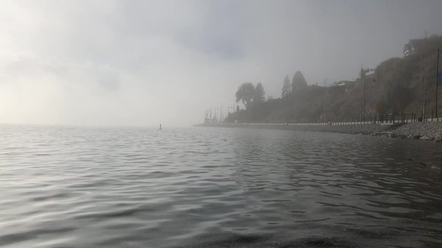 Lake on a eary grey day in the fog