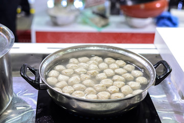 Boiling fish balls in flat pot