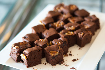 Walnut brownie stack, closeup chocolate cake in plate