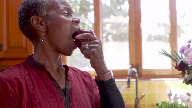 Concept - Senior African American woman choosing between drugs and food