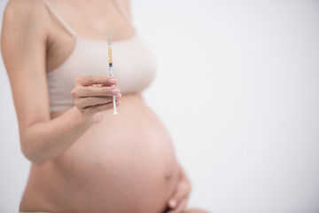 diabetes of pregnant. an asian pregnant is injecting Insulin pen. pregnant woman with syringe, isolated on white.  gestational diabetes. pregnancy health. gestational diabetes mellitus concept.