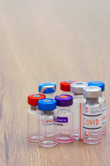 coronavirus outbreak, Virus and recovery concept, a group of vaccine bottles placed on the wooden table